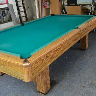 Sale Photo Thumbnail #115: Vintage pool table with light faux-wood grain finish and green felt playing surface.