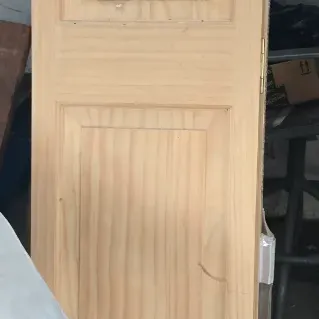 Sale Photo Thumbnail #31: Unfinished pine bi-fold closet door with a three-panel design, shown in original plastic packaging.
