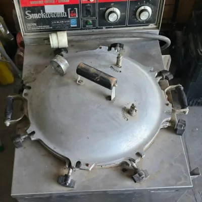 Sale Photo Thumbnail #15: Vintage Smokaroma commercial barbecue cooker and pressure smoker featuring a stainless steel construction, top control panel, and heavy-duty locking lid.