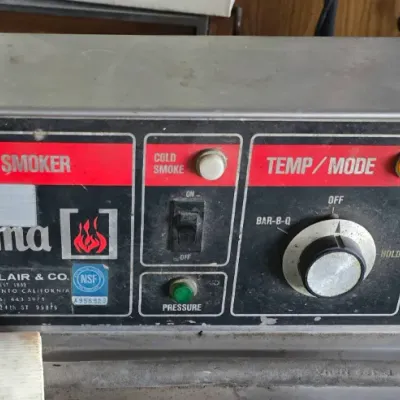 Sale Photo Thumbnail #14: Vintage Smokaroma commercial barbeque cooker and smoker control panel by J.N. Blair & Co., featuring manual temperature, mode, and timer control knobs.
