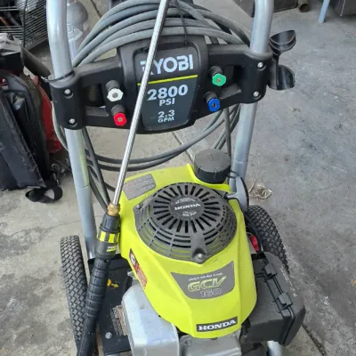 Sale Photo Thumbnail #67: Ryobi 2800 PSI 2.3 GPM gas pressure washer featuring a Honda GCV 160 engine, complete with hose and spray wand attachment.