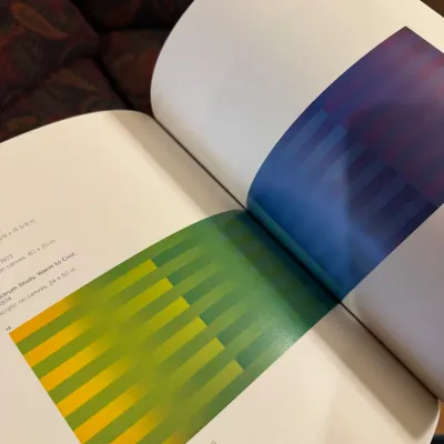 Open modern art monograph featuring full-page color plates of geometric abstract paintings, in very good condition.