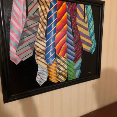 Framed contemporary painting depicting a collection of colorful patterned neckties against a dark background.