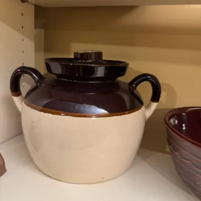 Vintage two-tone stoneware bean pot with matching lid and side handles.