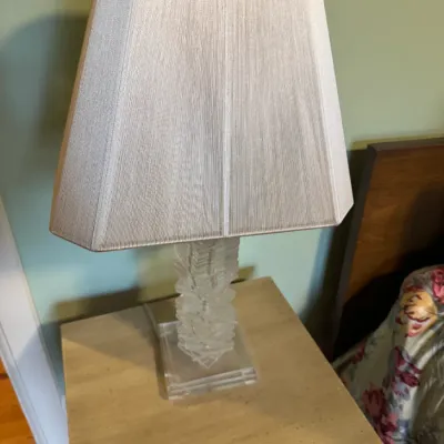 Modern clear acrylic stack-base table lamp featuring a textured fabric trapezoid shade.