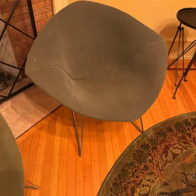 Mid-century modern Harry Bertoia style Diamond chair upholstered in grey fabric over a wire frame.
