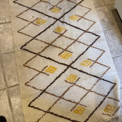 Hand-knotted Moroccan Beni Ourain style wool area rug runner featuring a geometric diamond lattice pattern with yellow accents and...