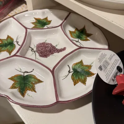 Hand-painted ceramic divided relish tray featuring a grape motif in the center surrounded by leaf-adorned compartments.