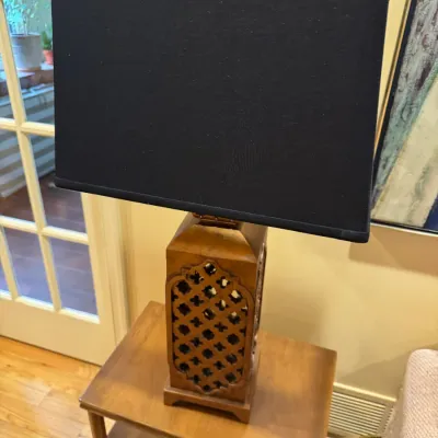Vintage carved wooden table lamp featuring a latticework body and a modern black rectangular shade.