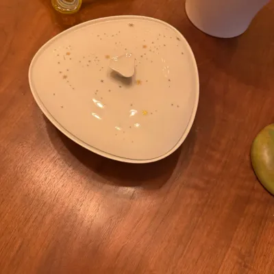 Mid-century modern triangular covered ceramic dish featuring a white glaze with atomic starburst and constellation details.