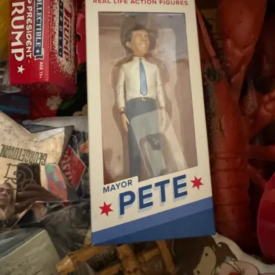 Fascinating collection of political novelties including a boxed Mayor Pete action figure by FCTRY alongside a President Trump Collectible...