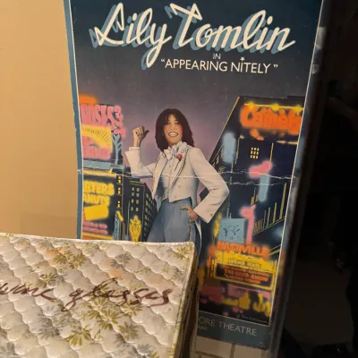 Vintage poster for Lily Tomlin in 'Appearing Nitely,' showing visible wear and a horizontal crease across the center.