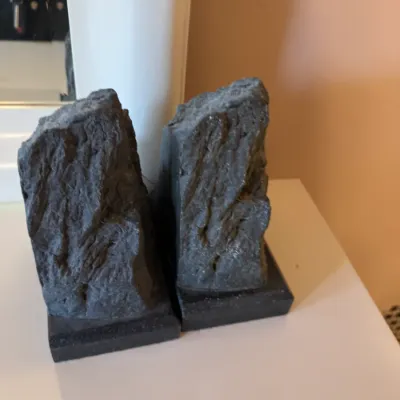 Pair of vintage natural rough-cut dark stone bookends, mounted on matching square bases.