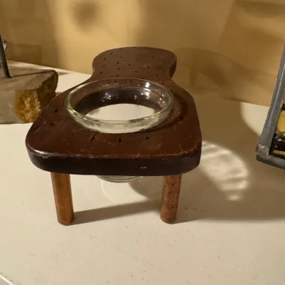 Vintage wooden cribbage board ashtray stand featuring a clear glass inset bowl.