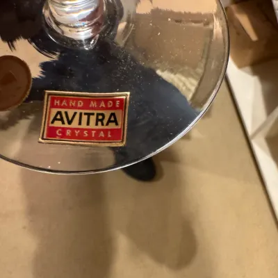 Close-up of the base of a hand-made Avitra Crystal glass showing the original foil maker's sticker.