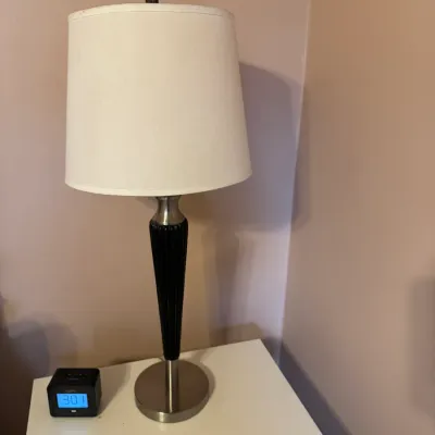 Modern tall table lamp with a fluted black body, brushed metal accents, and a white drum shade.