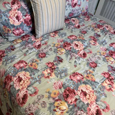 Vintage floral print comforter set featuring matching shams and a vertical striped accent pillow.