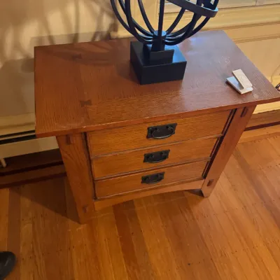 Mission Arts and Crafts style oak three-drawer nightstand or side table, featuring butterfly joinery detailing on the top and black iron...