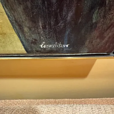Detail shot of an artist's signature on a framed oil painting.