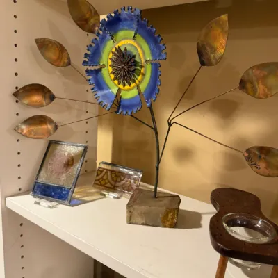 Mid-century C. Jere enamel and metal floral tabletop sculpture signed and dated '68, displayed alongside small stained glass accents.