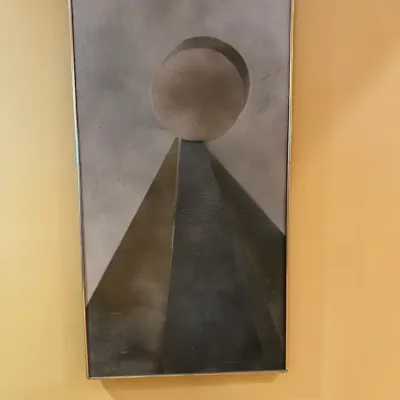 Mid-century modern geometric abstract painting on canvas depicting a sphere atop a pyramid, presented in a thin metallic frame.