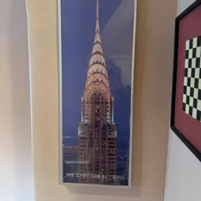 Framed poster featuring an architectural photo of The Chrysler Building in New York, set in a slim silver metal frame.
