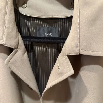 Vintage Sanyo tan trench coat featuring a pinstriped interior lining and button details.