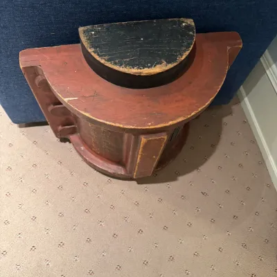 Vintage painted wooden foundry mold or industrial pattern piece, featuring a semi-circular stepped design with red and black distressed...