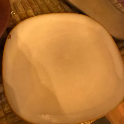 Vintage mid-century modern square ceramic platter with rounded edges and a beige glaze, displaying a minor chip on the upper left rim.