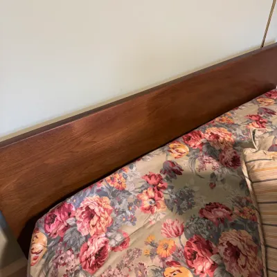 Mid-century modern wooden headboard featuring a clean-lined rectangular design with rich wood grain finish.