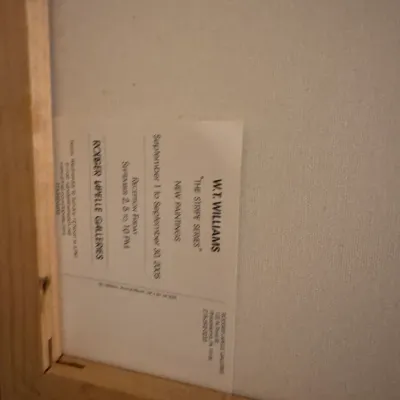 Back of a framed canvas painting featuring a Rodger LaPelle Galleries exhibition label for W.T. Williams' "The Stripe...