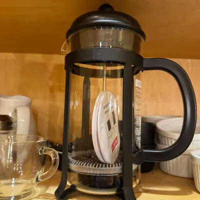 Bodum French press coffee maker with a black plastic frame and handle, appearing unused with original insert.