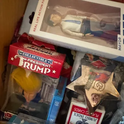 Assortment of boxed novelty items and collectibles including a President Trump troll doll, a Real Life Action Figure, a star-shaped...