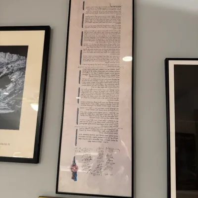 Framed print of the Israeli Declaration of Independence, featuring Hebrew text, signatures, and a seal, set in a tall black frame.