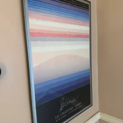Framed 1980 exhibition poster for Arthur Secunda at Le Chapitre gallery in Paris, featuring a layered landscape motif in a simple metal...