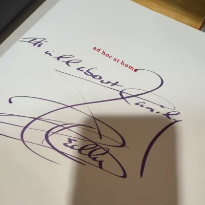 Autographed title page of the cookbook 'Ad Hoc at Home' by Thomas Keller, featuring a personalized inscription in purple marker.