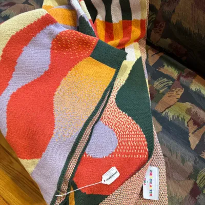 Zoe Schlacter x PMA colorful abstract knit throw blanket featuring bold geometric shapes and organic patterns in shades of orange,...