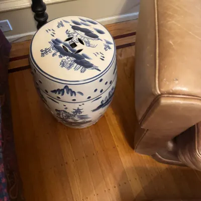Chinese blue and white porcelain garden stool featuring hand-painted landscape scenes and pierced coin details.