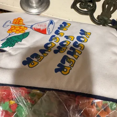 Novelty oven mitt printed with "Kosher for Passover" and a Kiddush cup graphic, along with various Passover-themed table decor...
