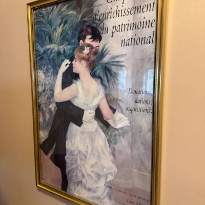 Framed vintage French exhibition poster featuring Pierre-Auguste Renoir's 'Dance in the City,' displayed in a thin...