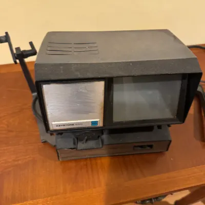 Vintage Keystone 250 movie viewer editor with integrated screen and film arms.