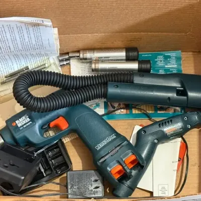 Sale Photo Thumbnail #363: Black & Decker VersaPak cordless power tool set, including a drill, rotary tool, flexible hose attachment, batteries, charger, and instruction manual.