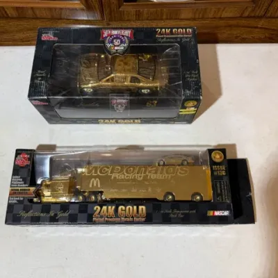 Sale Photo Thumbnail #73: Two 24K gold-plated NASCAR die-cast collectibles in original boxes, including a 50th Anniversary stock car and a McDonald's Racing Team transporter truck.