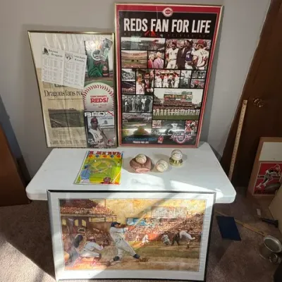 Sale Photo Thumbnail #432: Collection of Cincinnati Reds and baseball memorabilia, including framed photo collages, a framed vintage baseball art print, baseballs, and a pinball toy.