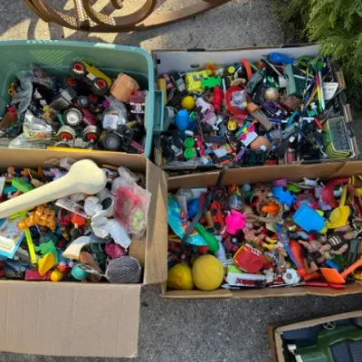 Sale Photo Thumbnail #441: Assorted cardboard boxes and plastic totes filled with vintage and modern children's toys, small action figures, and novelty items.