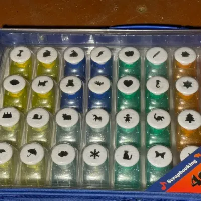 Sale Photo Thumbnail #367: Scrapbooking deluxe paper crafts set featuring 40 piece mini shape hole punches organized in a clear blue carrying case.