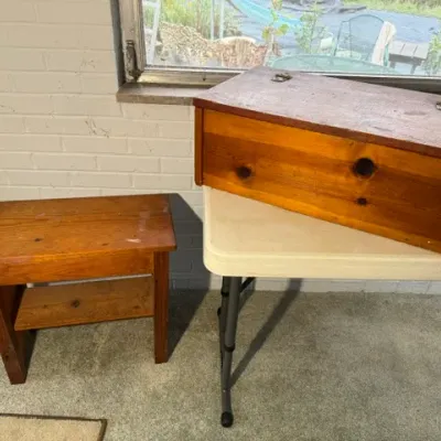 Sale Photo Thumbnail #173: Rustic wooden step stool with lower shelf alongside a handcrafted wooden storage box with metal hinges.