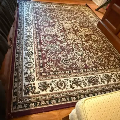 Sale Photo Thumbnail #170: Traditional oriental-style area rug featuring a burgundy field with intricate cream and floral scrollwork and a multi-tiered decorative border.