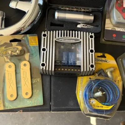 Sale Photo Thumbnail #472: Collection of aftermarket car audio accessories and automotive parts, including an Audiobahn crossover network, Scosche EFX power distribution strip, and XScorpion wiring.