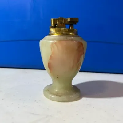 Sale Photo Thumbnail #49: Vintage urn-shaped alabaster or onyx table lighter featuring brass mechanism and natural pinkish-brown veining.
